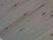1990 Ford Bronco - The image shows a close-up of light-colored wood paneling with visible knots and grain patterns.