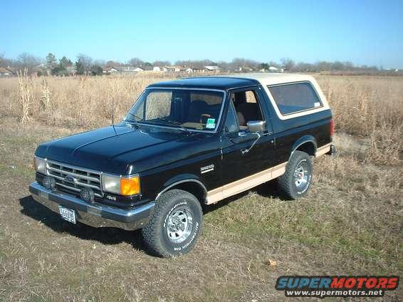 1988 Ford Bronco, black with tan top, 3/4 front view