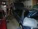 1990 Ford Mustang - Two cars, a blue 1990 Ford Mustang and a red car, are parked in a garage with their hoods open.