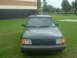 1989 Ford Escort - This car appears to be a hatchback from the late 1980s, possibly a Ford Escort, but the exact model year is unclear from the image.