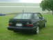 1989 Ford Escort - Rear view of a black 1989 Ford Escort hatchback with a spoiler and aftermarket wheels.