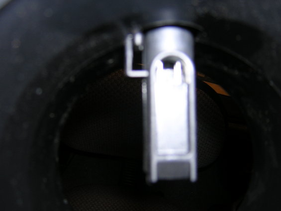 Close-up of a silver and black mass air flow sensor inside a dark housing