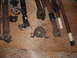 1994 Jeep YJ - Various driveshafts and associated parts are laid out on a wooden surface, showing signs of rust and wear.
