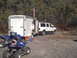 2003 Yamaha RAPTOR 660 - Two blue Yamaha ATVs are parked in front of a white SUV and a trailer, with an American flag flying from the trailer.
