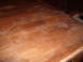 1988 Ford Bronco - This image shows a heavily scratched wooden surface, possibly a table, with some white residue.