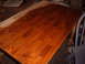 1988 Ford Bronco - A dining table is shown in the process of being refinished, with stain applied to a portion of its surface.