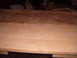 1988 Ford Bronco - A wooden surface shows a transition from stained to unstained wood, with some items in the background.