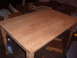 1988 Ford Bronco - A wooden dining table with turned legs sits in a workshop, ready for refinishing.
