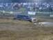 1989 GMC Jimmy - SUV struggling in a mud pit during an event.