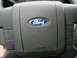 1997 Ford F-150 - Close-up of a Ford steering wheel, showing the blue oval emblem and part of the dashboard.