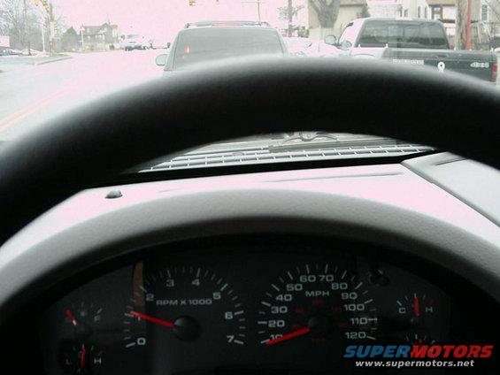 Dashboard view of a 2005 Ford F-150, showing speedometer and RPM gauges. Traffic ahead