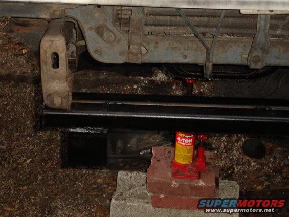 Front bumper and grille area of a vehicle supported by a hydraulic jack
