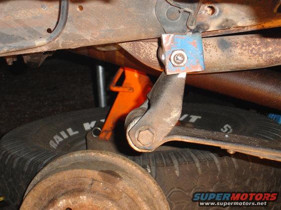Blue bracket on suspension part, spare tire visible