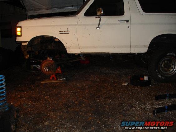 1989 Ford Bronco side view, front suspension removed and vehicle on jack stands