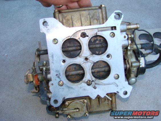 Carburetor with four throttle plates, held by a hand