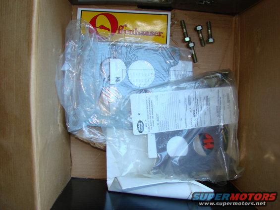 Offenhauser intake manifold parts in a cardboard box with bolts and paperwork