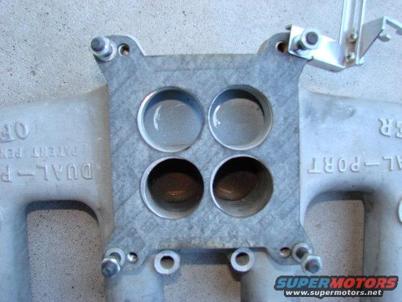 Close-up of a dual-port intake manifold with four openings. Text reads 'DUAL-PORT' and 'PATENT PENDING'