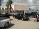 1997 Ford Ranger - A modified black pickup truck is displayed with its hood open, alongside other vehicles and a trailer.