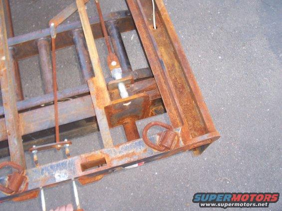 left rear corner with rear support jack locking handle pulled out in to "unlocked" position