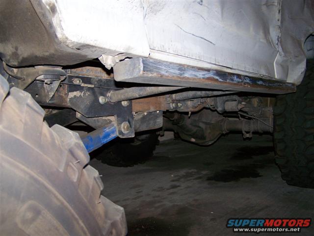 Vehicle undercarriage with large tires and suspension parts