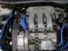 1999 Ford Taurus - Close-up of a Ford 24 valve V6 engine, showing intake manifold and blue hoses.