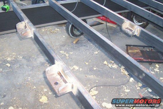 Spare tire cradle made to hang from these three mounts. They are made from 1/2" steel plate, and welded right to the crossmembers