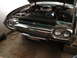 1992 Ford Crown Victoria - Front view of a 1960 Ford Thunderbird with the hood open, revealing the engine and chrome grille.
