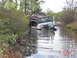 1995 Dodge 1500 - Two off-road vehicles are stuck in water, with a person attempting to assist.