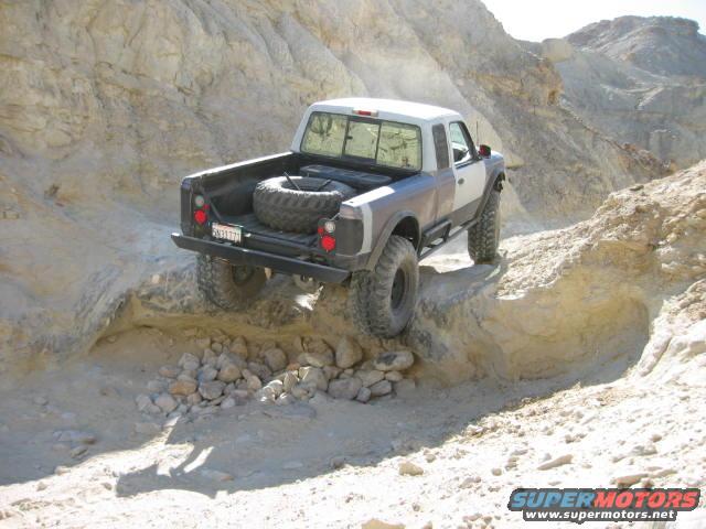 Pickup truck driving on a rocky, off-road trail