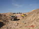 1996 Ford Bronco - A group of SUVs and Jeeps navigate a desert terrain under a clear blue sky.