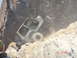 1996 Ford Bronco - Off-road vehicle stuck on a steep, dusty, rocky incline, kicking up dust.