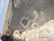 1996 Ford Bronco - A Jeep Wrangler is stuck on a steep, dusty incline, with onlookers observing the situation.