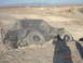 1996 Ford Bronco - Off-road vehicle is stuck in a deep dirt ditch with large tires.