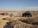 1996 Ford Bronco - Two Jeeps in a desert setting, one is stuck in a deep ditch.