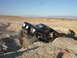 1996 Ford Bronco - A 1996 Ford Bronco maneuvers through a challenging off-road terrain with steep dirt walls.