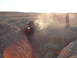 1996 Ford Bronco - Jeeps navigating challenging terrain in a dusty desert environment at sunset.