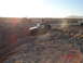1996 Ford Bronco - Jeeps driving through a challenging off-road course during the day.