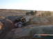1996 Ford Bronco - Jeeps tackling an off-road trail in a desert environment with spectators watching.