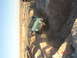 1996 Ford Bronco - A teal Jeep CJ-7 navigates a steep dirt embankment in a desert landscape.