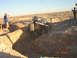 1996 Ford Bronco - A Jeep Wrangler attempts to traverse a challenging off-road trench in a desert landscape.