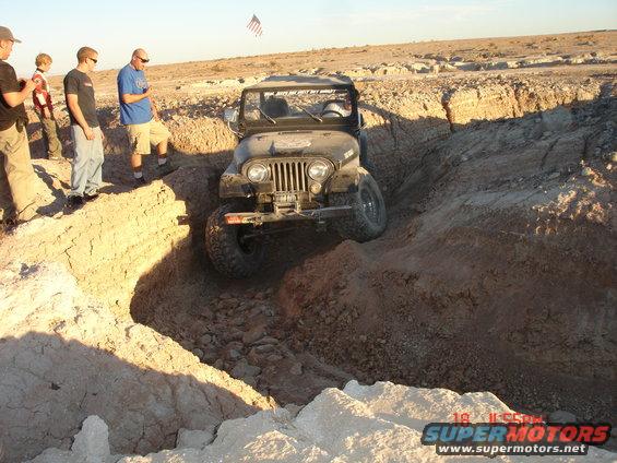 Jeep Wrangler navigating a dirt trench
