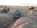 1996 Ford Bronco - Off-road vehicles tackle a challenging terrain with steep inclines and rocky obstacles.
