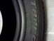 1983 Ferrari Enzo - A close-up view of a tire, showing the brand name and size information.
