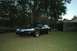 1999 Lincoln Town Car - A black 1999 Lincoln Town Car is parked on a grassy lawn in front of trees and a house.