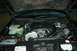 1999 Lincoln Town Car - The engine bay of a car is shown with a prominent turbocharger and custom air intake system.