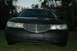 1999 Lincoln Town Car - Front view of a black sedan with a distinctive grille and headlights.