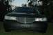 1999 Lincoln Town Car - Front view of a black Lincoln Town Car, likely a 1998 model, with a prominent chrome grille.