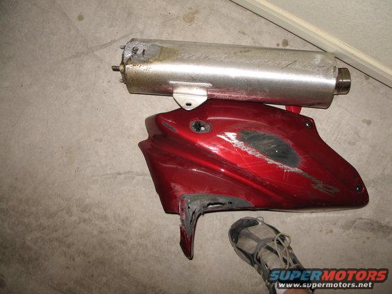 motorcycle exhaust pipe and red fairing with scuffs