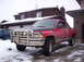 1989 Chevrolet Blazer - This red pickup truck is equipped with a heavy-duty bull bar and off-road tires, ready for winter conditions.