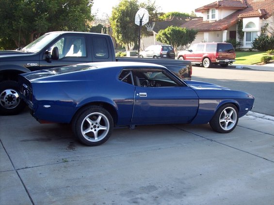 Blue 1971 Ford Mustang with roll cage, seen from the side